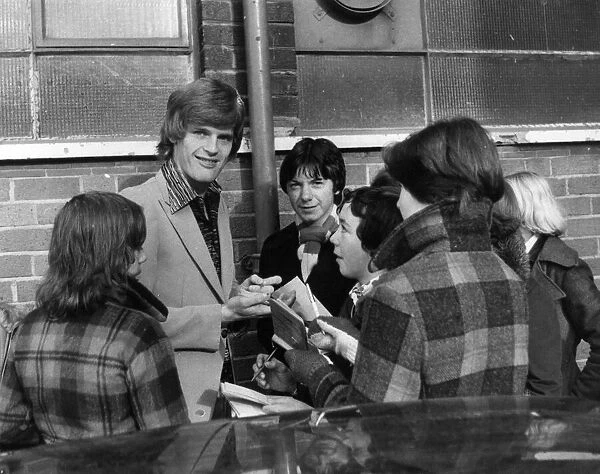 Gordon McQueen signs autographs for young fans outside Old Trafford, Manchester