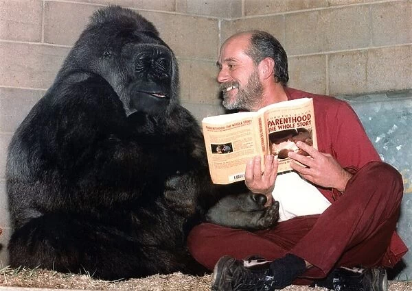 A gorilla takes advice from Mike Colbourne, park keeper for Bristol Zoo