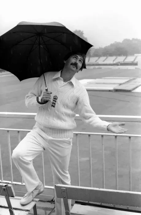 Framed Print : Graham Gooch England cricketer takes shelter from the rain under an umbrella as Framed Print : Graham Gooch England cricketer takes shelter from the rain under an umbrella as