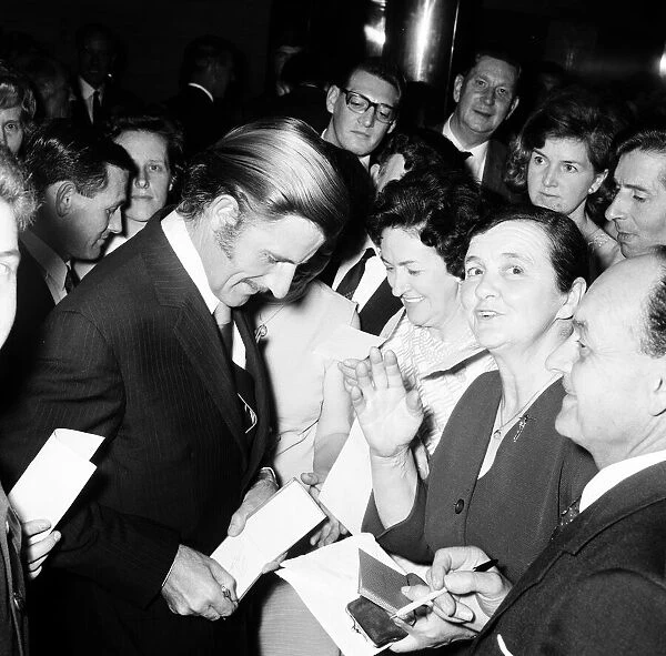 Graham Hill signing autographs at the Daily Mirror Motoring Celebrity Dinner at the Savoy