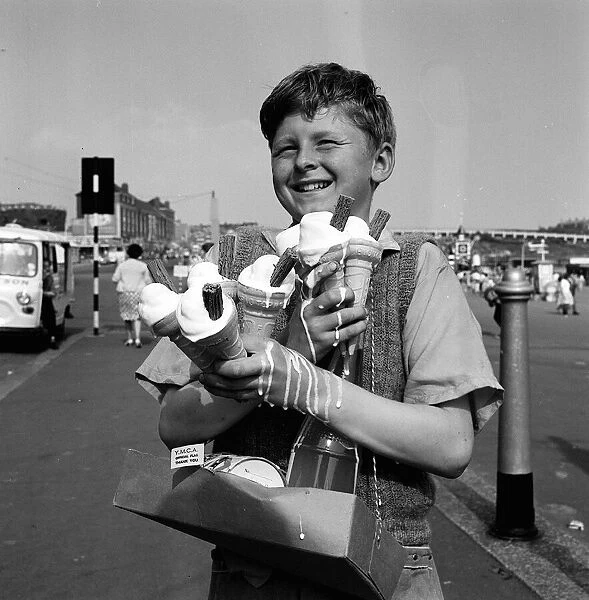 Graham Mansey age 12 a flag seller for the YMCA helping carry ice creams on the beach at