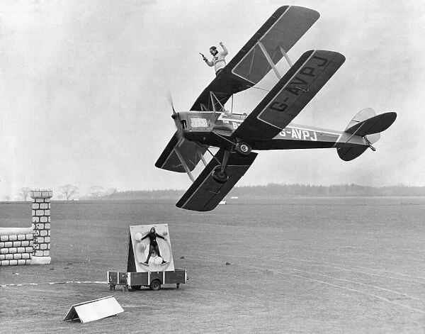 Graham Tyson on the wings of the Tiger moth with a Colt 38 ready to shoot from a moving