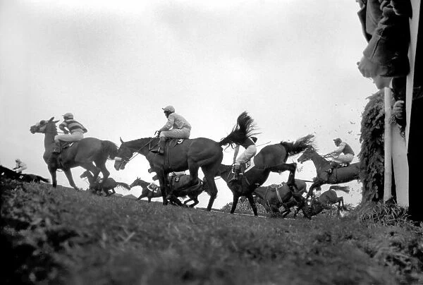 The Grand National at Aintree: Landing after jumping the canal turn is the eventual
