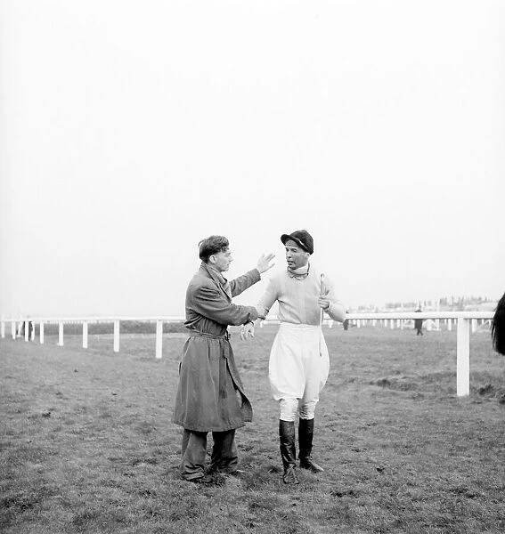 Grand National at Aintree Racecourse. Dejected jockey Dick Francis receives