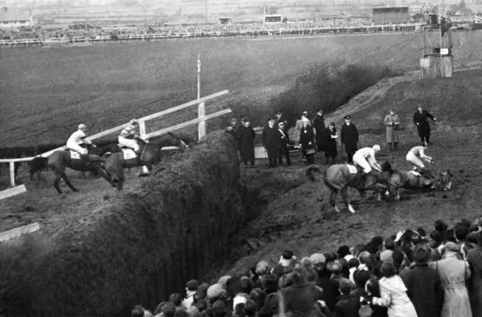 Framed Print : Grand National: The horse lying third falls; on fourth horse falls  /  third