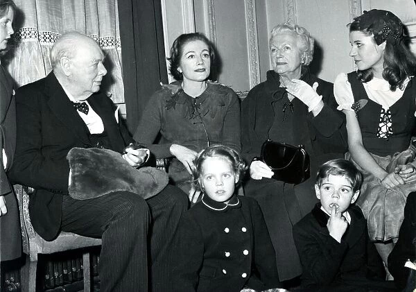 Grandpa Sir Winston-hand in muff-presides over a family group at London