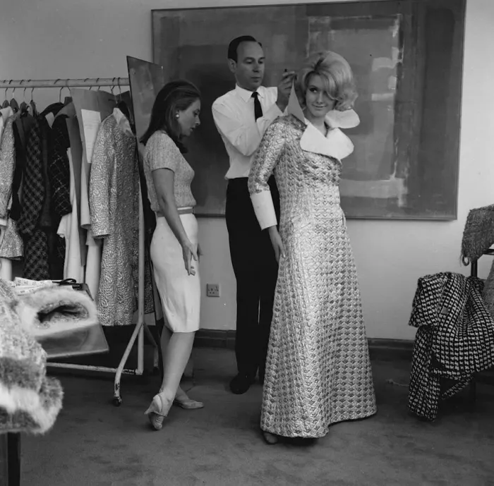 Framed Print : Graziella Fontana fashion June 1965 Model being helped into a long checked coat Framed Print : Graziella Fontana fashion June 1965 Model being helped into a long checked coat