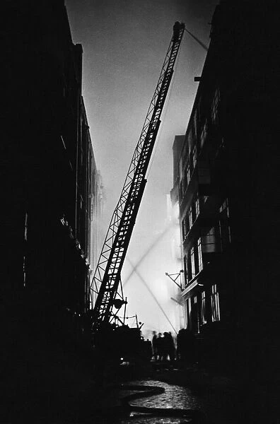 The Great Fire of London. Personnel and turntable ladders at work on the city fire