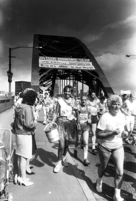 Framed Print : The Great North Run 24 July 1988 - One of the runners collecting for charity carrying her Framed Print : The Great North Run 24 July 1988 - One of the runners collecting for charity carrying her