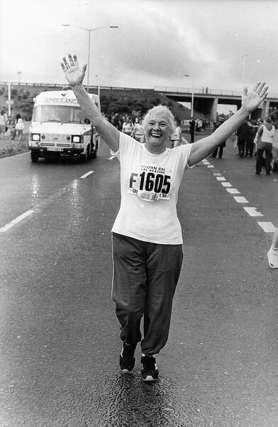 The Great North Run 27 June 1982 - Arms aloft runner Gladys Humpsih, 70