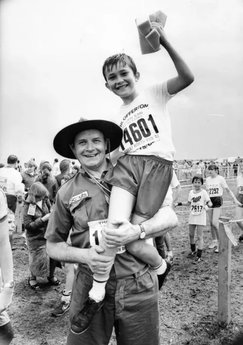Framed Print : The Great North Run 27 June 1982 - Scout leader Glyn Bathgate hoists aloft one of his