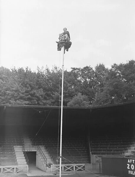 The Great Reno sitting on top of a 60 ft pole at Brighton Zoo after an arguement with his