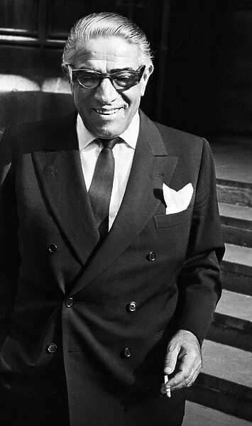 Greek shipping tycoon Aristotle Onassis attends the Law Courts in London to sue 77 year
