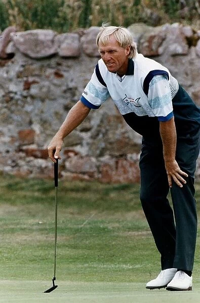 Greg Norman golfer lining up a put