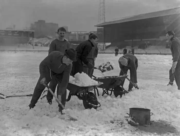 Framed Print : Grounds staff at Bristol Rovers Eastville Stadium struggle to clear snow from the pitch