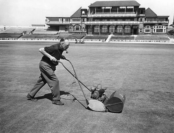 Groundsman Bert Flack add the finishing touches to the test wicket