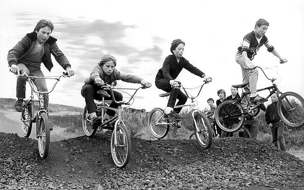 A group of children try out an obstacle on the new BMX track