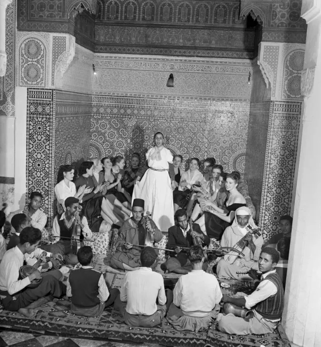 Framed Print : A group of French actresses enjoying a performance by local musicians