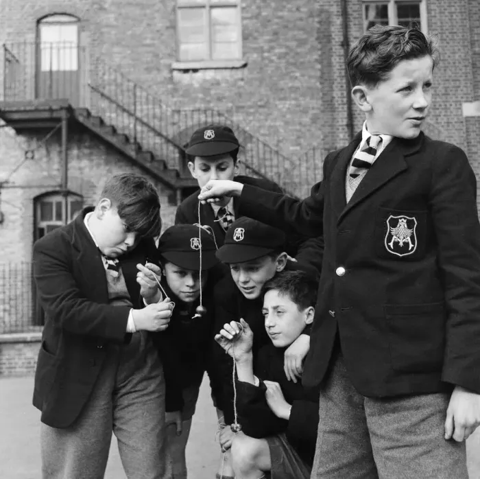 Framed Print : A group of friends taking part in a game of conkers at their school. September 1950 Framed Print : A group of friends taking part in a game of conkers at their school. September 1950