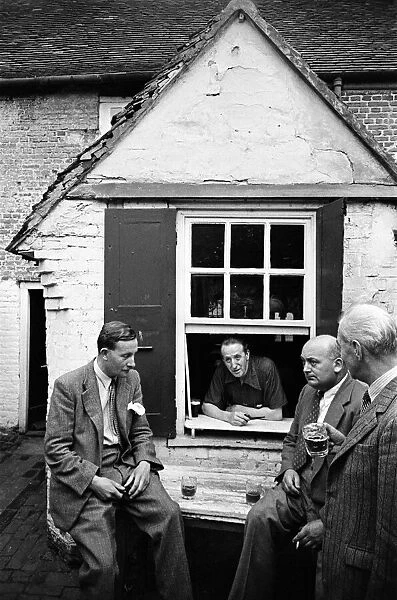 A group of men enjoy a game of Bat and Trap at a pub in Kent