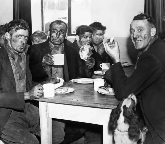 Framed Print : A group of miners enjoying a meal after the opening of a pithead canteen at Isabella Pit