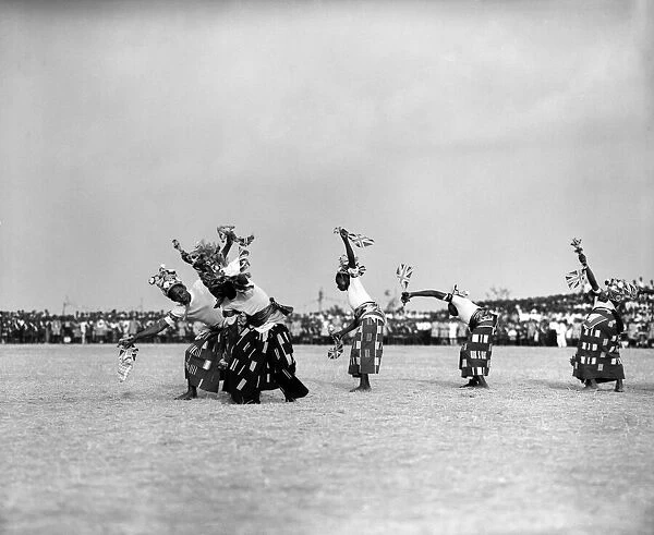 A group of Nigerian dancers who are performing in traditional costume for Queen Elizabeth