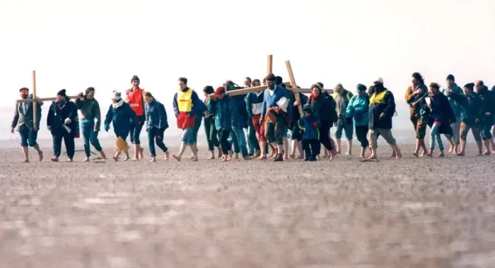 Framed Print : A group of pilgrims crossing the causeway at Holy Island on their way to St Framed Print : A group of pilgrims crossing the causeway at Holy Island on their way to St