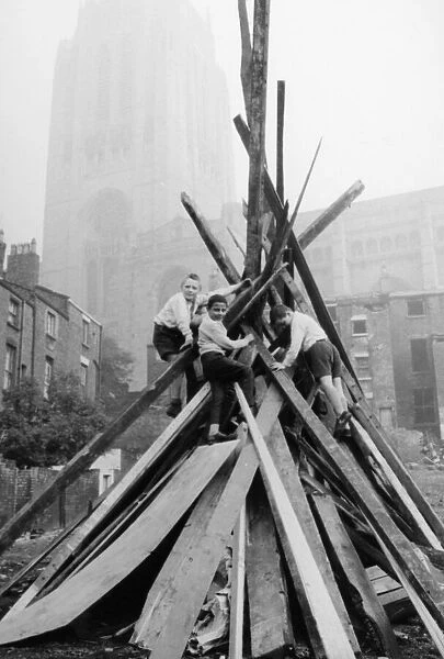A group of schoolboys seen here adding the final touches to their bonfire in the shadow