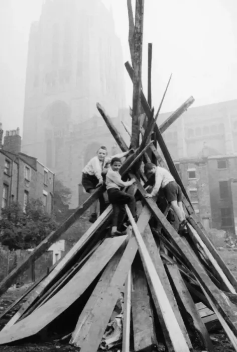 Framed Print : A group of schoolboys seen here adding the final touches to their bonfire in the shadow Framed Print : A group of schoolboys seen here adding the final touches to their bonfire in the shadow