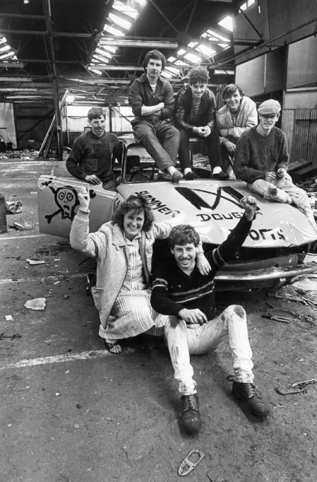 Framed Print : A group teenagers pleased with their efforts after having worked on an old car