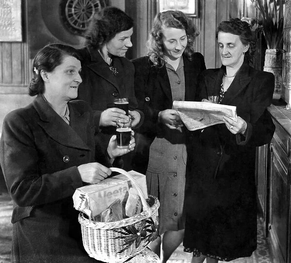 A group of women standing reading the newspaper, one woman in the foreground holding a