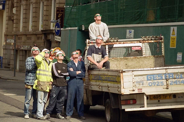 A group of workmen in Liverpool city centre watching the solar eclipse. 11th August 1999