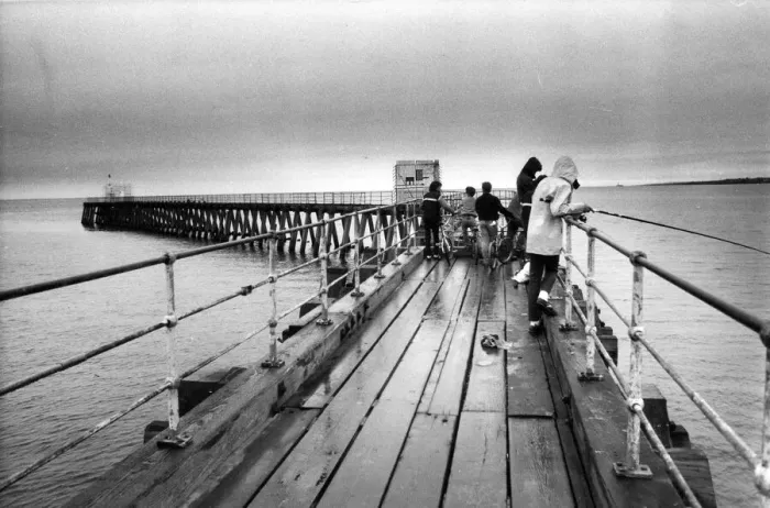 Framed Print : A group of young anglers prepare to enjoy a quite afternoon fishing on Blyth Pier