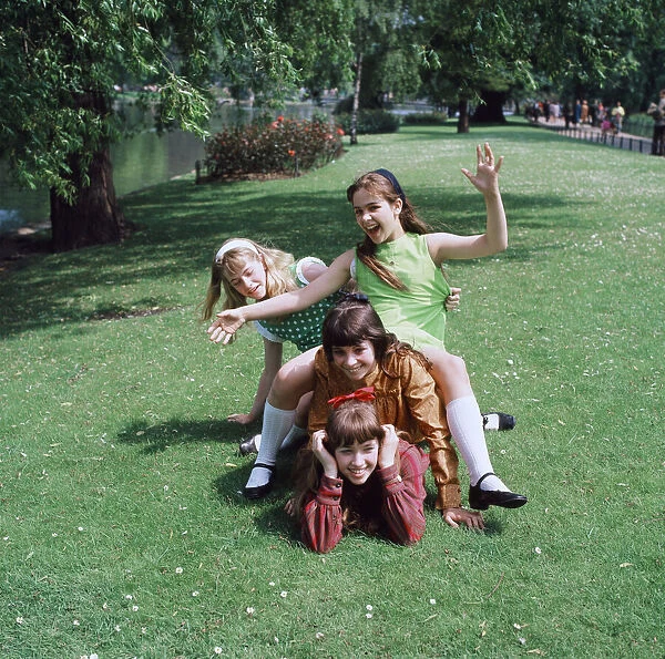 Group of four young girls playing in their local park. Circa 1970