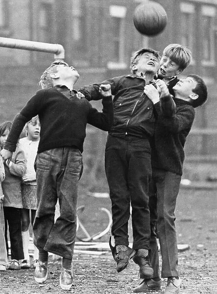 A group of youngsters enjoying a game of football on waste ground on Tyneside