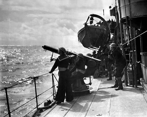 Guarding our Convoys. Men aboard a destroyer on escort duty fire warning shots to
