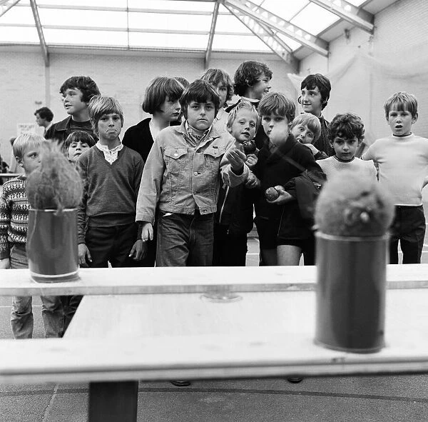 Guisborough School fete, children playing on the coconut shy stall. 1972