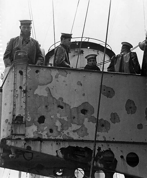 H. M. S. Exeter returns with improvised deck repairs. Pictured, damage to the bridge