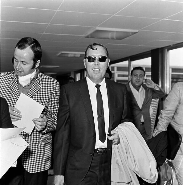 Bill Haley arrives at London Airport. Leather clad rockers from his fans club were at