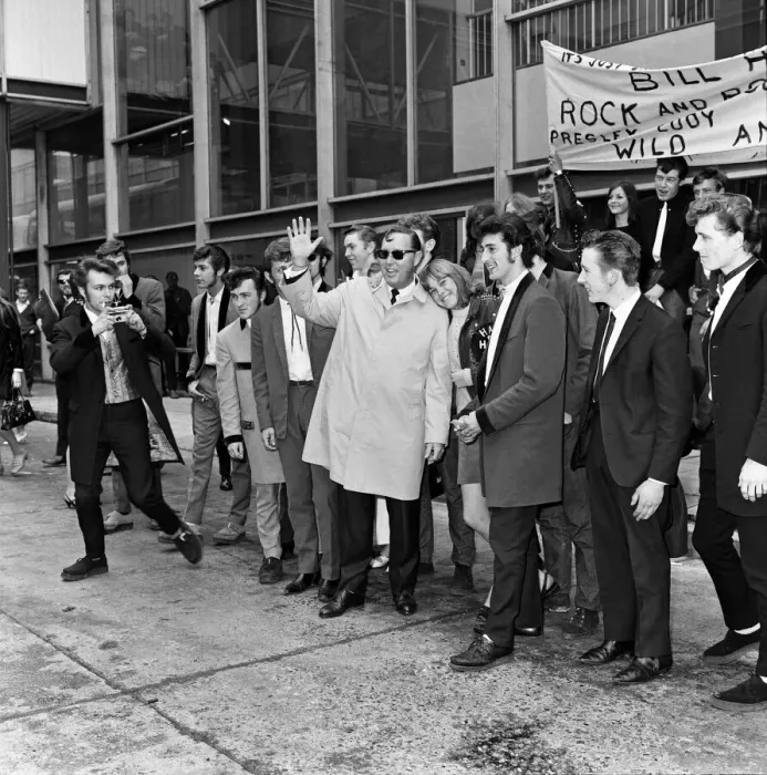 Framed Print : Bill Haley arrives at London Airport. Leather clad rockers from his fans club were