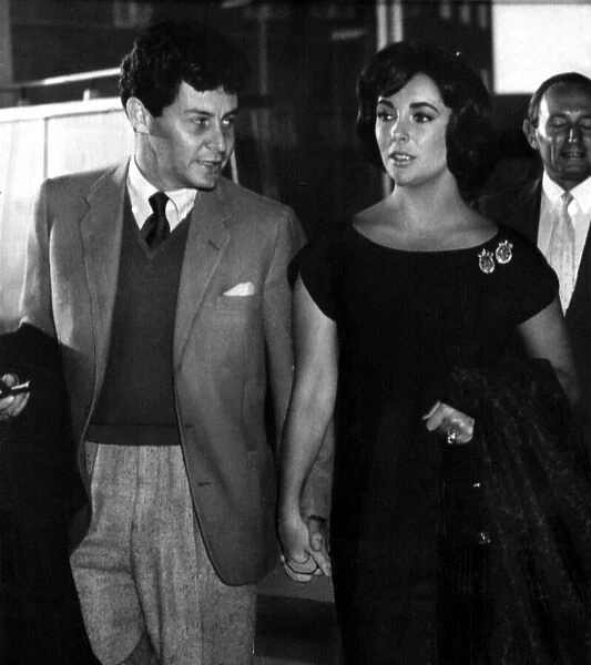 Hand in hand Elizabeth Taylor and husband Eddie Fisher leave London Airport for Paris 13