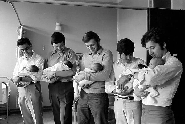 A handful of fathers have a little get together with their babies at the Mile End