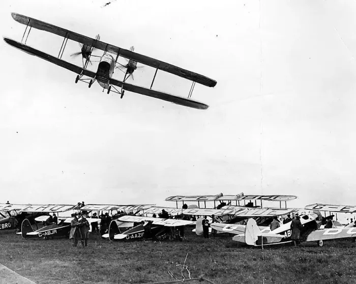 Framed Print : A Handley Page W-8 banks over the parked aircraft at Cramlington airfield