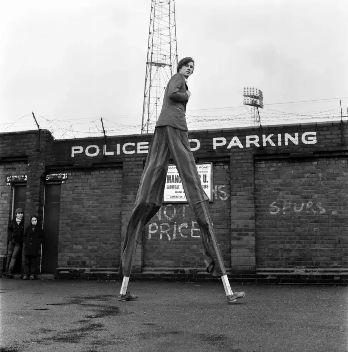 Framed Print : Very handy when you are on stilts - football ground walls might as well not be there