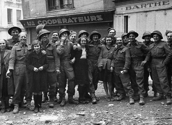 A happy group of British troops and French civilians photographed in Caen following