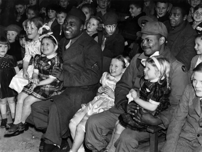 Framed Print : Happy picture of the children with black American soldiers enjoying a programme of Framed Print : Happy picture of the children with black American soldiers enjoying a programme of