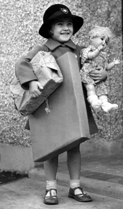 Framed Print : Happy young girl dressed up in coat and hat holding parcels under one arm Framed Print : Happy young girl dressed up in coat and hat holding parcels under one arm