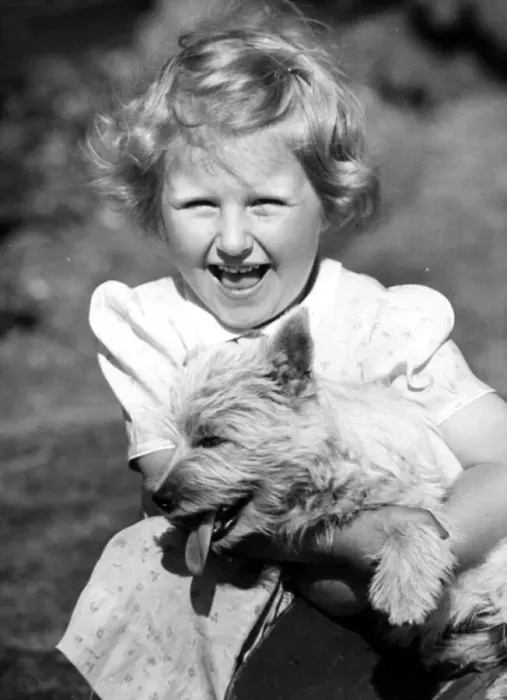 Framed Print : Happy young girl holding onto her pet dog Circa 1945 P044448