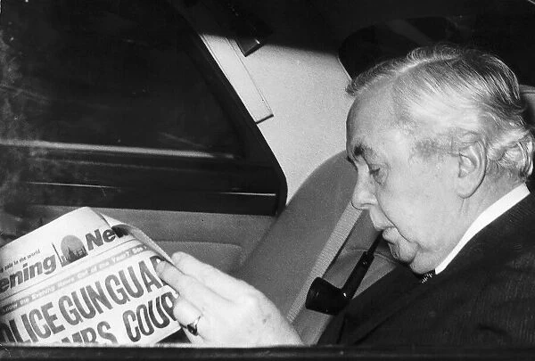 Harold Wilson Labour Prime Minister of Britain smoking his pipe as he rides in his car