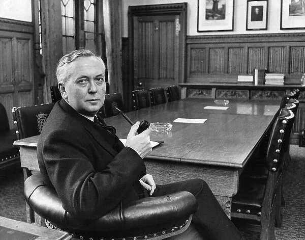 Harold Wilson sits at the head of the table in the leader of the oppositions room at